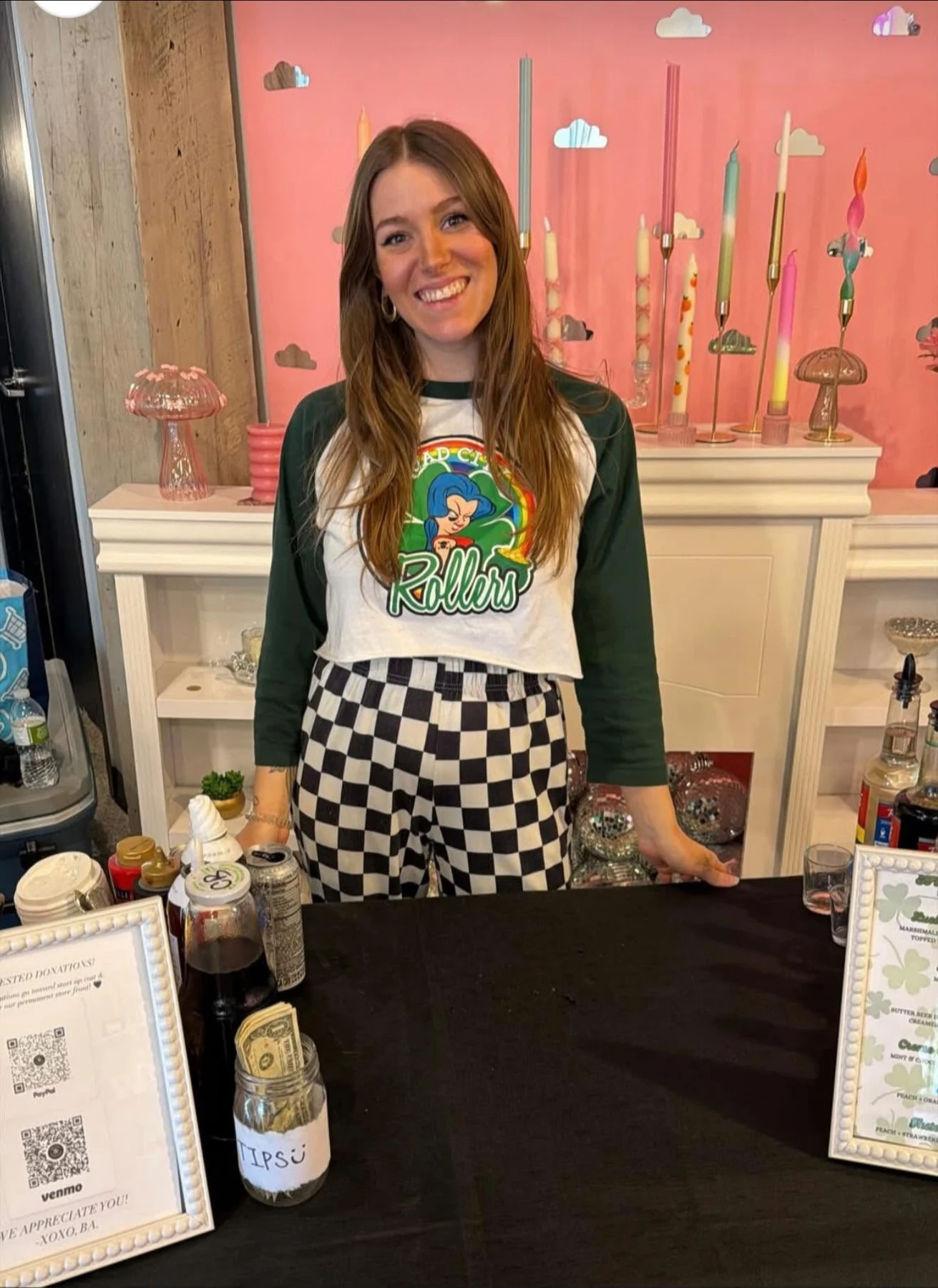 A smiling team member behind the counter at a Brewed Awakening pop-up
